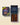 An open dark blue gift box labeled Maison Marou Creations and 'Celebrate the Moon Festival' is shown beside its matching closed outer box. The open box contains multiple compartments filled with assorted chocolates and nuts, photographed on a warm cream background with soft shadows.